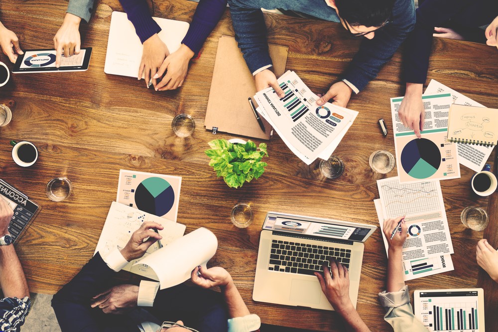 Group of marketing experts discuss facts and figures.