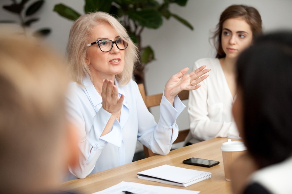 Business Woman Speaking to Employees