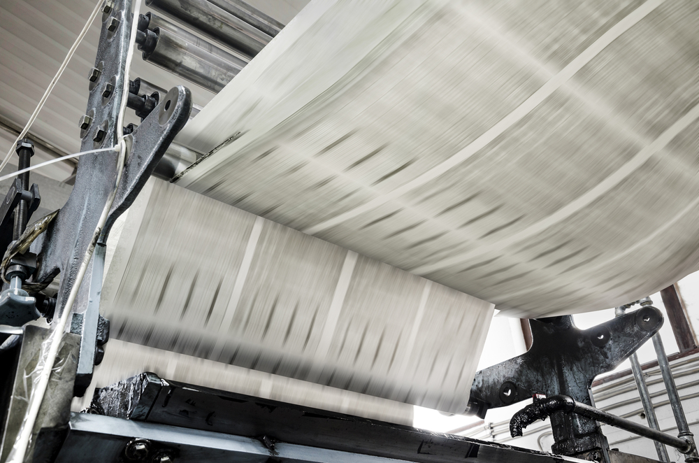 Newspaper printing press in action.